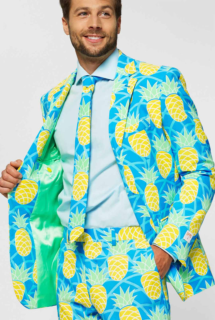 Pineapple print men's suit with bright colors by man close up