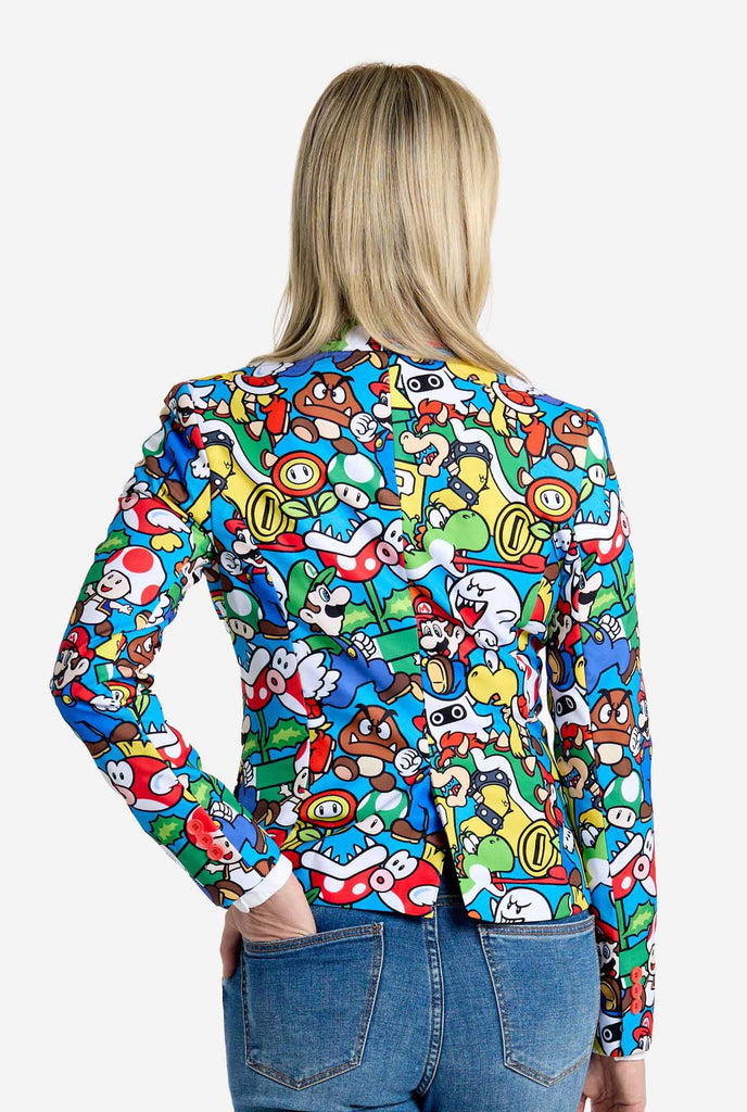 Vrouw draagt ​​een all-over print Super Mario blazer met iconische Super Mario karakters. De basis is lichtblauw, maar er is ook geel, rood en wit.