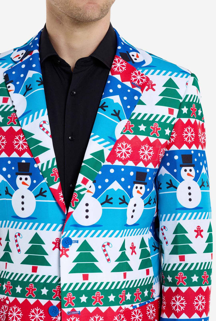 Man wearing Christmas blazer for men with Christmas winter figures. Man also wearing a black pants and black men's shirt. Chest close up.