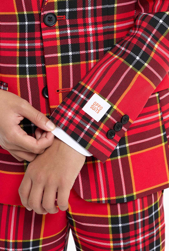 Tiener met een rood tartan kerstpak, close up mouw.