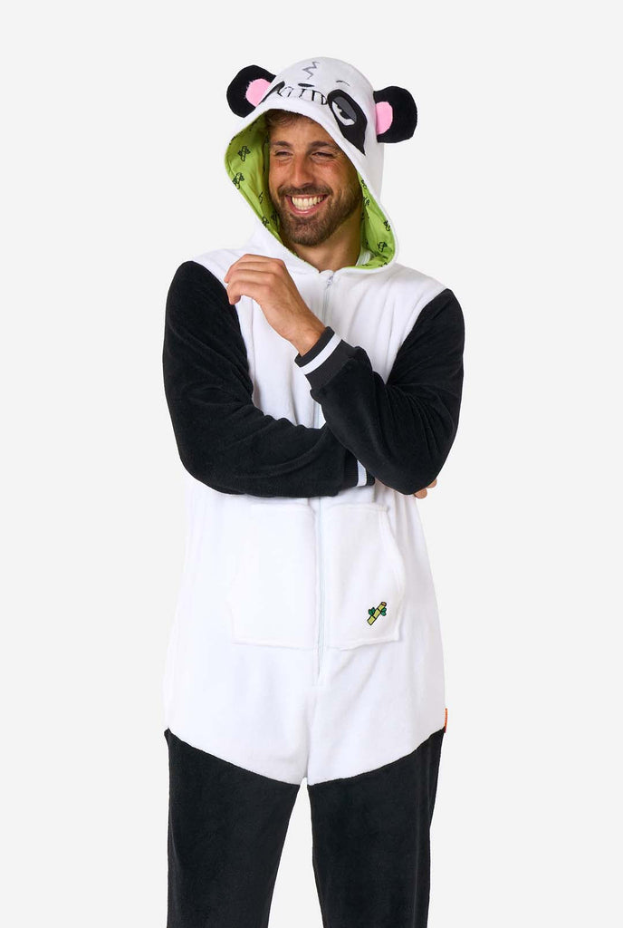 Een man draagt een zwart met witte panda onesie, onderdeel van de OppoSuits dieren onesie collectie.