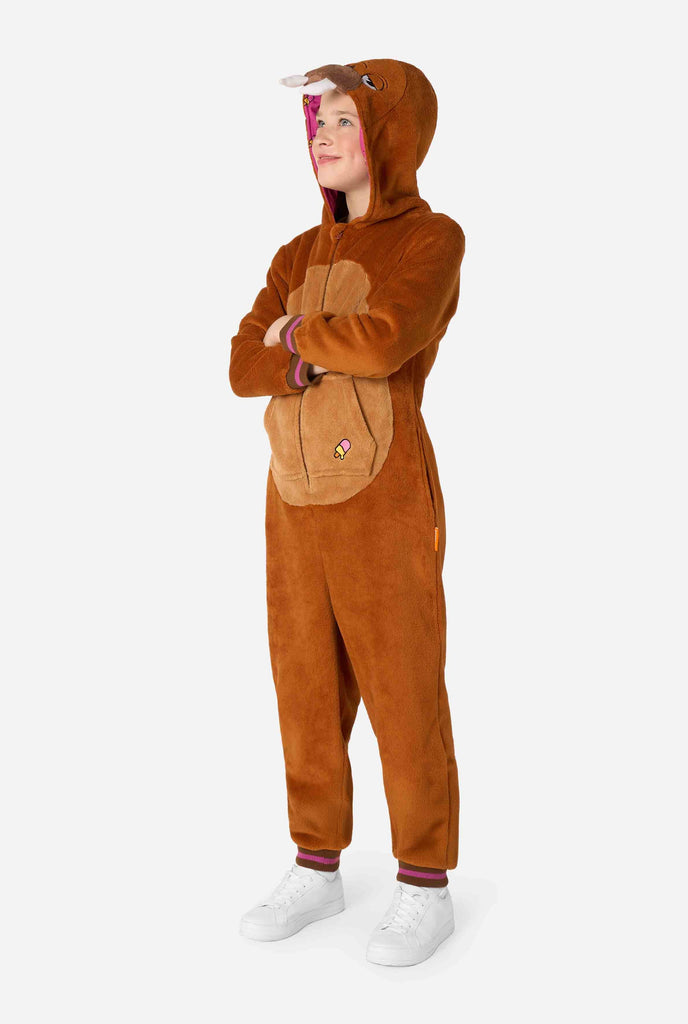 A cheerful kid wearing a brown kids onesie designed as a walrus. The onesie features a hood with fangs, stitched gloves resembling paws, and playful walrus details, perfect for cozy lounging or costume parties. Full body image.